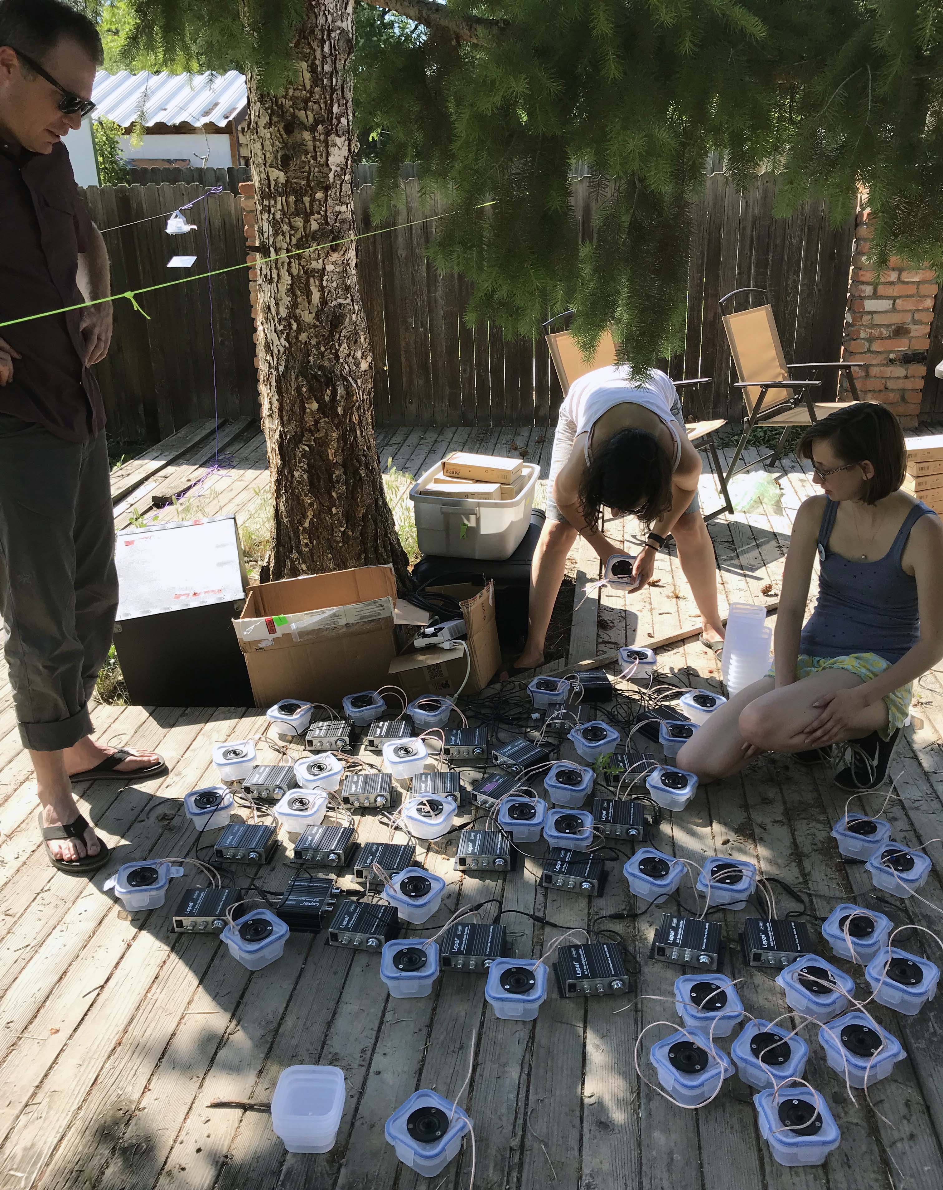 Our custom-built speaker array was the result of trial and error. The biggest challenge was scaling up from one, 4-speaker unit to 25, 4-speaker units driven by 25 amplifiers. Here, Dr. Jesse Barber (left), Juliette Rubin (middle) and Lemon Beckham (left) are testing the array design in Idaho, U.S.A. 